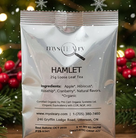 Mysteary Hamlet tea package with Christmas tree and berries in the background