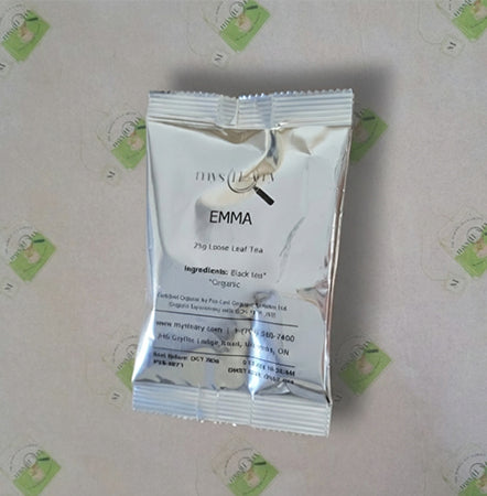 Tea package labeled 'EMMA' on a light background with green logos.