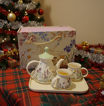 Tea set with floral design on a tray, Christmas decorations in the background