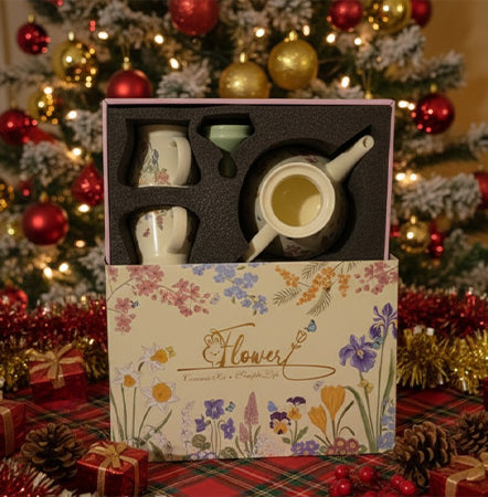 Set of mugs in a decorative box with floral design, Christmas tree in the background