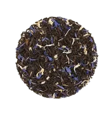 Tea ball with black tea leaves and blue flowers on a white background