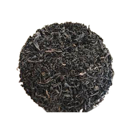 Close-up of black tea leaves on a white background