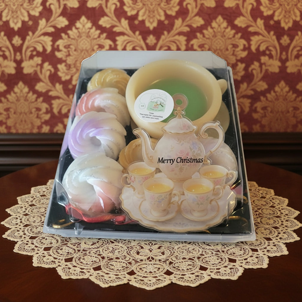 Set of Christmas-themed candles in a decorative box on a wooden surface